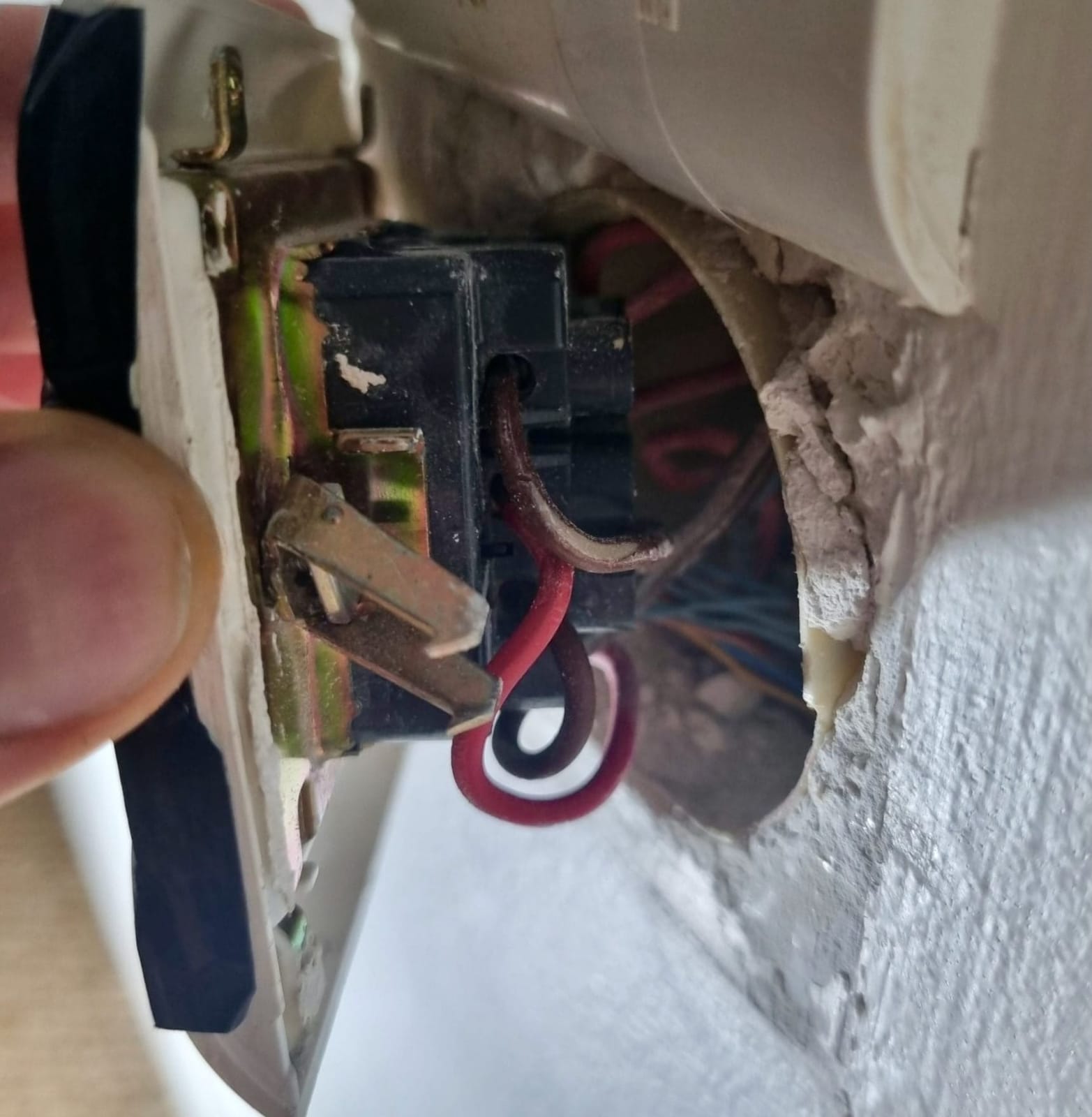 Ancien interrupteur Legrand fixé par des crochets sur son support