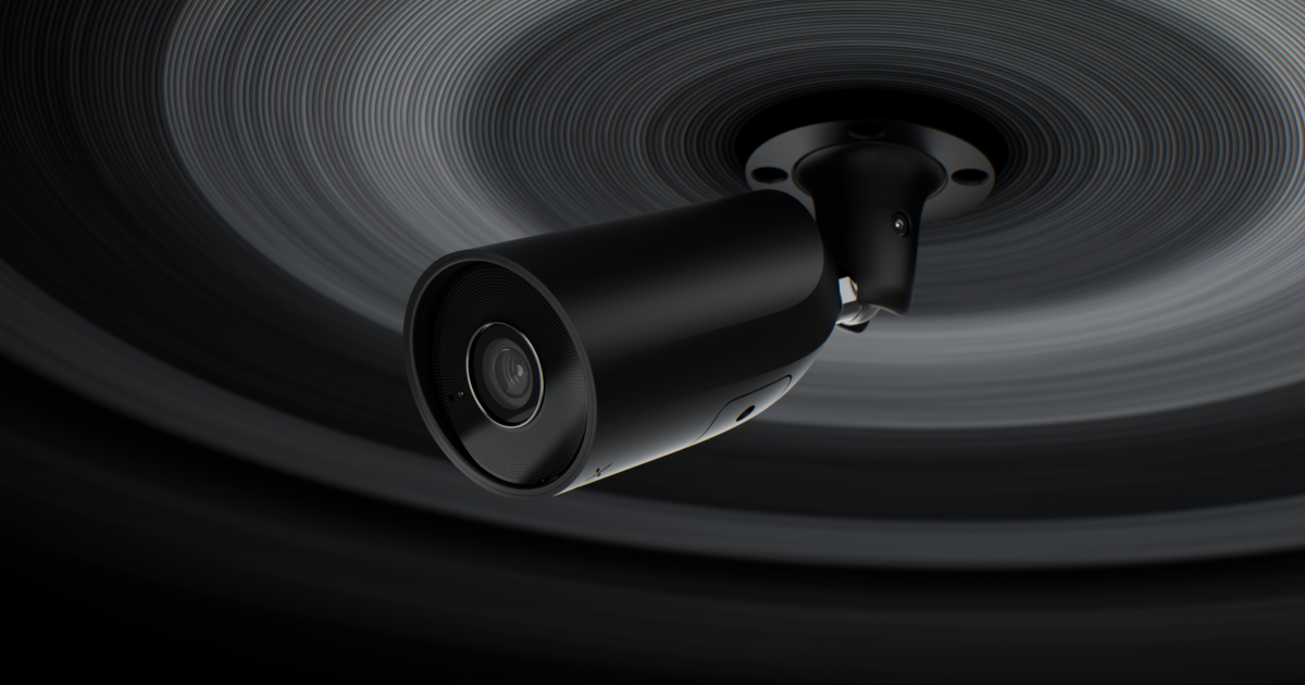 Caméra de surveillance noire de type bullet fixée au plafond avec un fond artistique à motifs circulaires concentriques gris et noirs