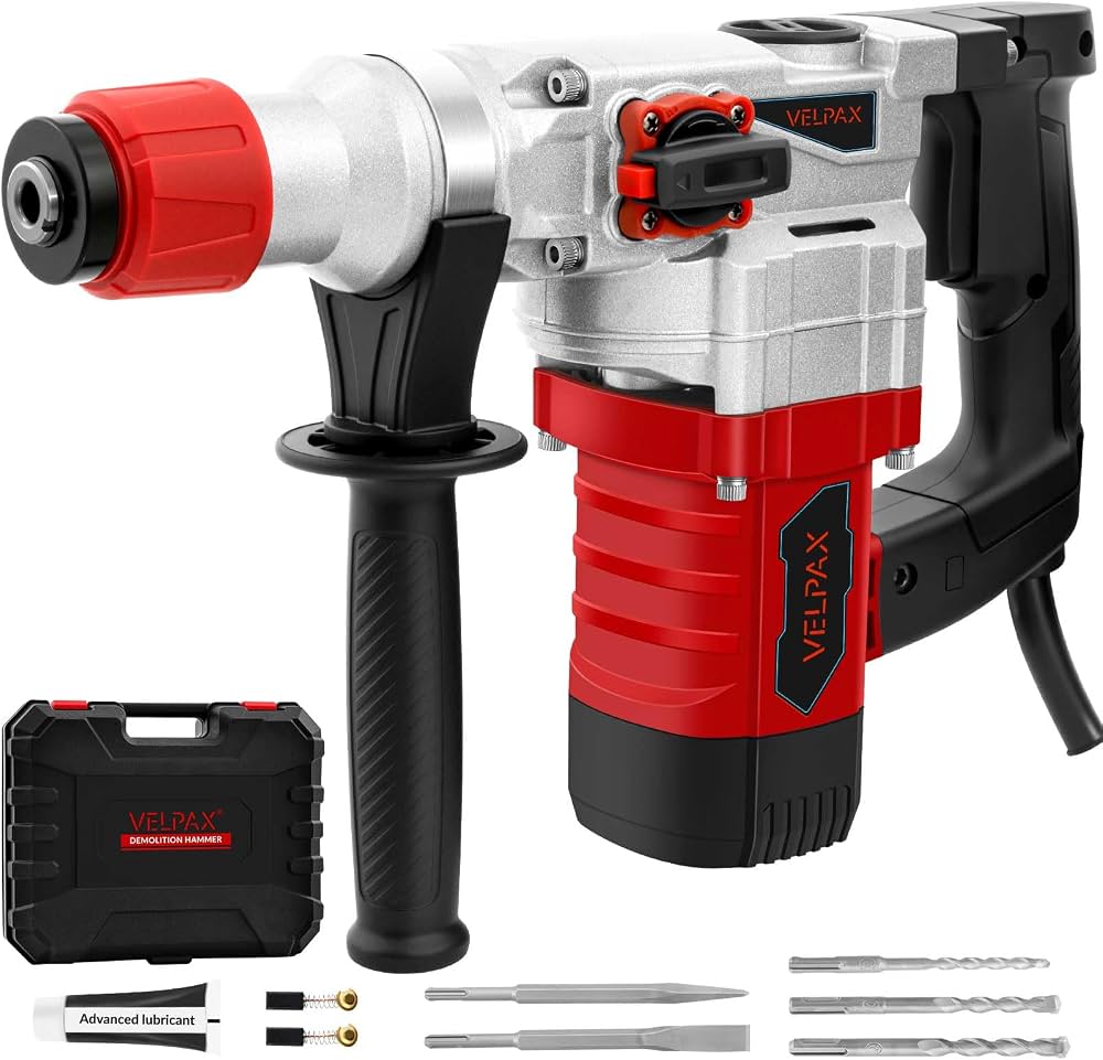 Un marteau perforateur électrique rouge et argent de la marque Velpax présenté avec son coffret, ses forets et ses burins.